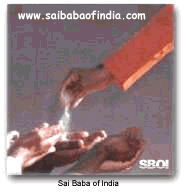 Sai Baba giving vibhuti from His hand